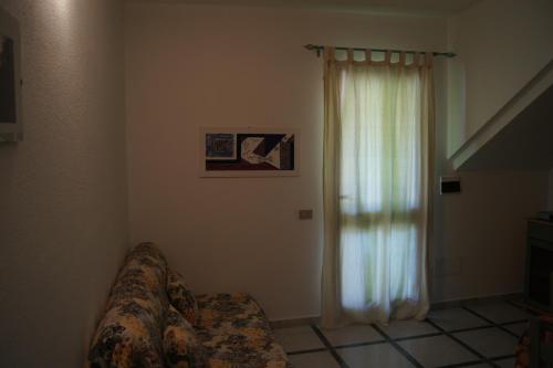 a living room with a couch and a window at Casa Luminosa in Cala Liberotto