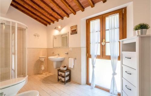 a bathroom with a sink and a toilet and a window at Le Silerchie in Camaiore