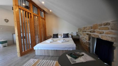 a bedroom with two beds and a fireplace at Apartmani Goga in Skradin