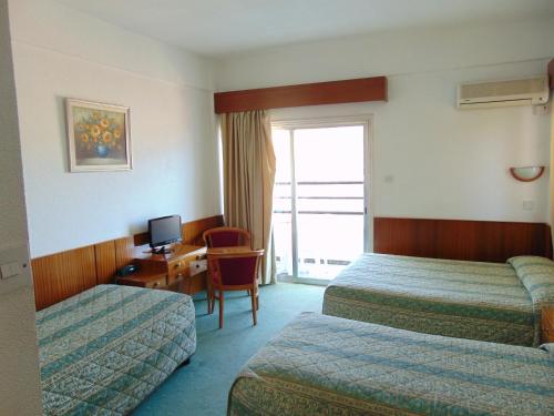 A bed or beds in a room at Hellas Hotel