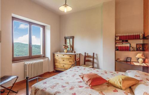 a bedroom with a bed and a window at La Quiete in Moggiona