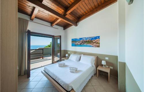 a bedroom with a bed with a view of the ocean at Stunning Home In Trinitadagultu Ot With 6 Bedrooms, Wifi And Outdoor Swimming Pool in Costa Paradiso