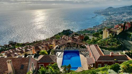 an aerial view of a house next to the water at Sea and Sun 4 You - Palheiro Village in Funchal