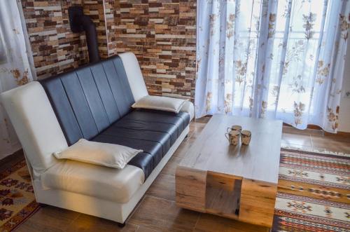 a living room with a couch and a coffee table at Vila Alić in Šišava