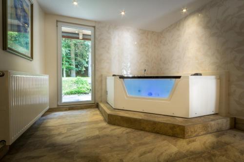 a large bathroom with a large tub in a room at Kulinarium an der Glems in Stuttgart