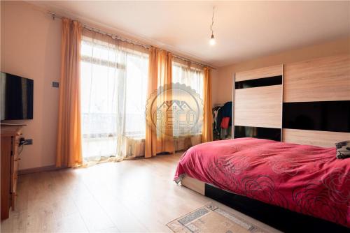 a bedroom with a red bed and a large window at VILA ORADEA LUX in Oradea