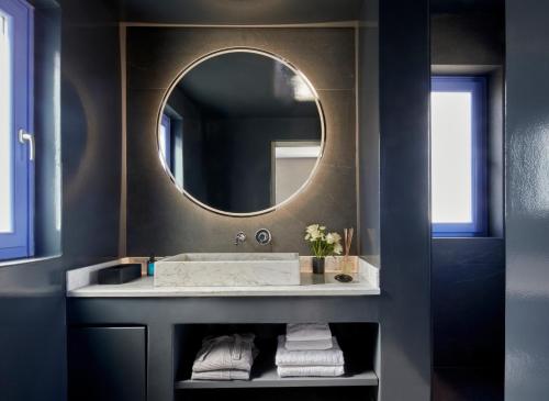 a bathroom with a sink and a mirror at My Santorini Villa, Pyrgos Luxury in Pirgos