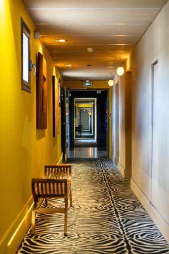 a corridor with a bench in a hallway at Hotel Bastide & SPA - Villa de Lourmarin in Lourmarin