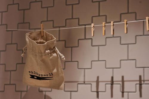 a paper bag hanging on a clothes line in front of a wall at Hyatt Place Zurich Airport the Circle in Kloten