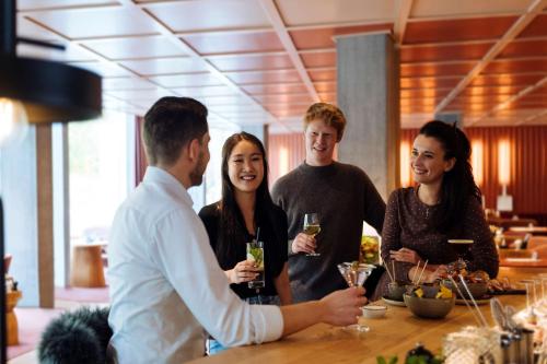 a group of people standing around a table with drinks at Hyatt Place Zurich Airport the Circle in Kloten