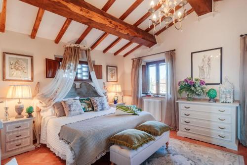 a bedroom with a bed with a canopy at VILLA LAJATICO Farmhouse with Private Pool in Peccioli