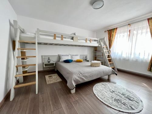 a bedroom with bunk beds and a bed with a rug at Casa Matteo - Rustic & cosy getaway in Zărnești in Zărneşti