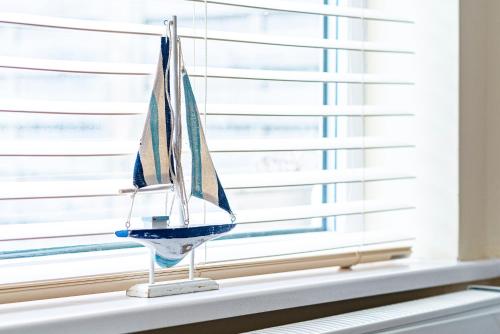a toy boat sitting on a window sill at Greyfriars in Clacton-on-Sea
