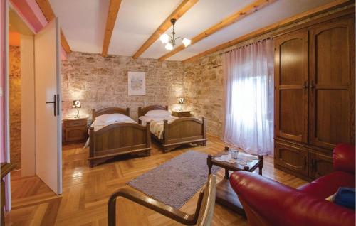 a bedroom with two beds and a couch and a window at Pet Friendly Home In Basici With Outdoor Swimming Pool in Bašići