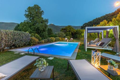 um quintal com uma piscina e um gazebo em Villa Elizabeth em Capannori
