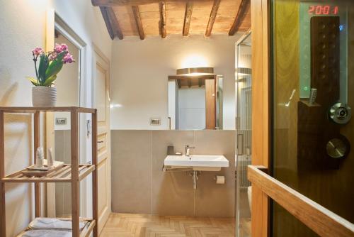 a bathroom with a sink and a mirror at B&B Le Logge Luxury Rooms in Siena
