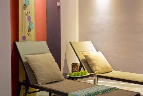 two chairs and a table with a plate of green apples at Leonardo Hotel Jerusalem in Jerusalem