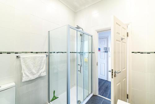 a bathroom with a shower and a glass door at Greyfriars in Clacton-on-Sea