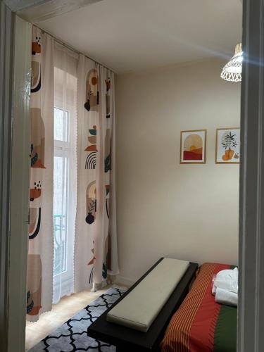 a bedroom with a bed and a window with shoes at Nelly Guesthouse in Istanbul