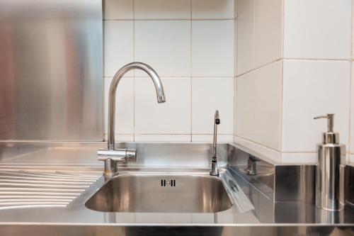 a stainless steel kitchen sink with a faucet at Al Platano Orientale in Bologna