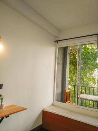 an empty room with a window and a balcony at Crystal Resort in Badulla