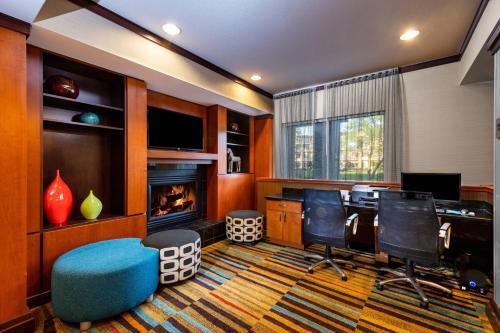 a living room with a desk and a fireplace at Fairfield Inn Battle Creek in Battle Creek