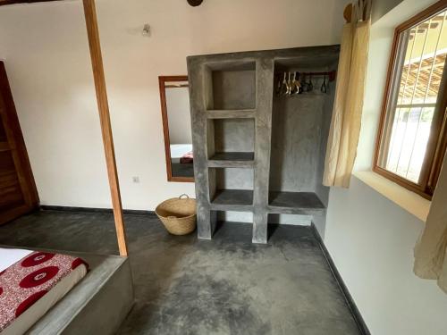a bathroom with a ladder and a mirror in a room at Diana Place in Paje
