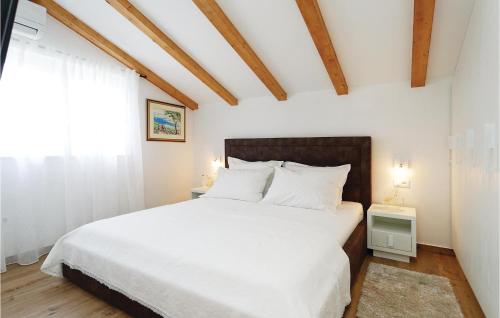 a bedroom with a large bed with white sheets at Lovely Home In Sibenik With Wifi in Šibenik