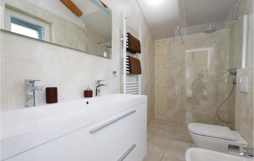 a bathroom with a sink and a toilet and a shower at Lovely Home In Sibenik With Wifi in Šibenik