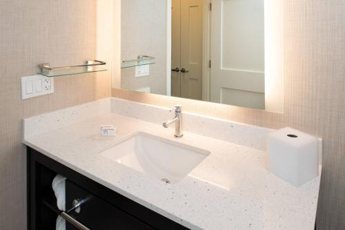 a bathroom with a sink and a mirror at Residence Inn by Marriott Bakersfield West in Bakersfield