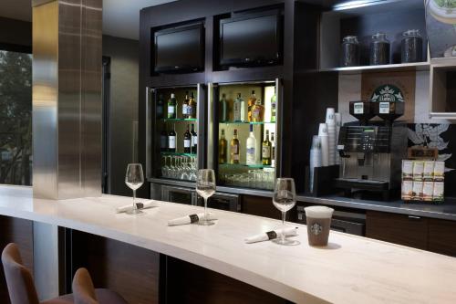 a bar with wine glasses on a counter at Courtyard by Marriott Albuquerque Airport in Albuquerque