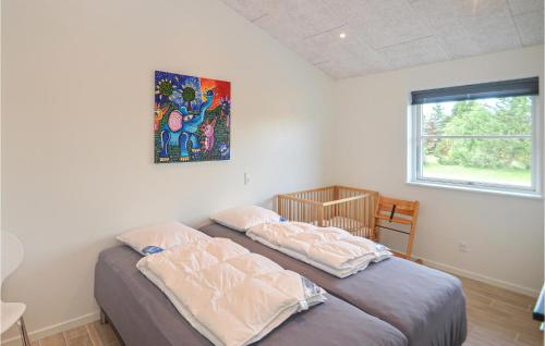 a bedroom with two beds and a painting on the wall at Stunning Home In Vggerlse With Wifi in Marielyst