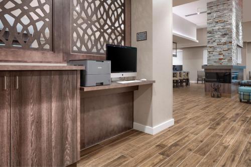 an office lobby with a computer and a television on a counter at Residence Inn by Marriott Decatur Emory Area in Decatur