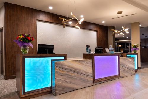 a lobby with two counters with purple and blue lights at Residence Inn by Marriott Charlotte Northlake in Charlotte