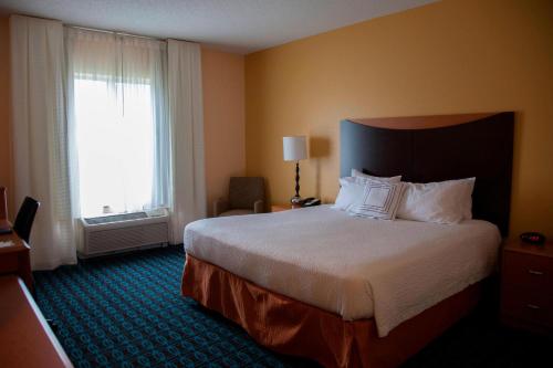 a hotel room with a large bed and a window at Fairfield Inn & Suites Bedford in Bedford