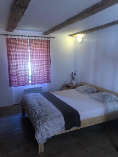 ein Schlafzimmer mit einem Bett und zwei Fenstern in der Unterkunft Ubytování Újezdec u Prachatic 