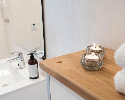 a bathroom with two candles on a wooden counter at Villa Fregn in Ljørdal