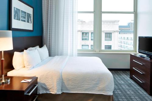 a hotel room with a bed and a window at Residence Inn Milwaukee Downtown in Milwaukee