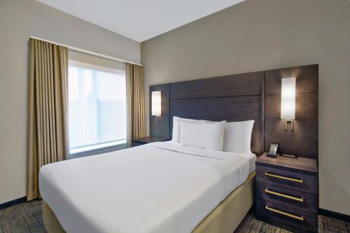 a large white bed in a hotel room with a window at Residence Inn by Marriott Reading in Wyomissing