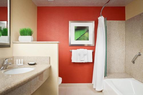 a bathroom with a sink and a shower and a toilet at Courtyard Richland Columbia Point in Richland