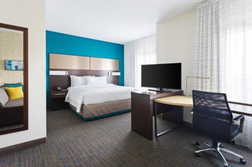 a hotel room with a bed and a desk with a computer at Residence Inn by Marriott Houston West/Beltway 8 at Clay Road in Houston