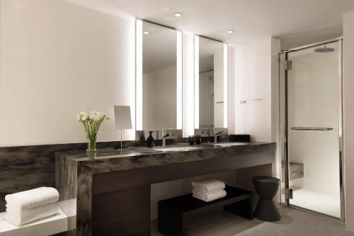 a bathroom with a sink and a shower at Courtyard by Marriott Shin-Osaka Station in Osaka