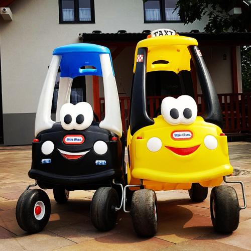 two toy cars are parked next to each other at Domki RADAWA na Kliszówce in Radawa