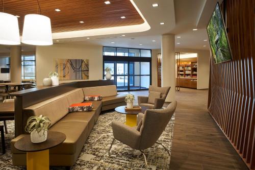 a lobby with a couch and chairs and tables at SpringHill Suites by Marriott Winter Park in Orlando