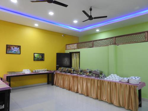 a banquet hall with a table with white dishes at Kohua Bon - Kaziranga in Hatikhuli
