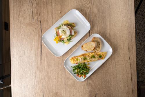 two plates of food on a wooden table at Hotel Restovna in Jíloviště