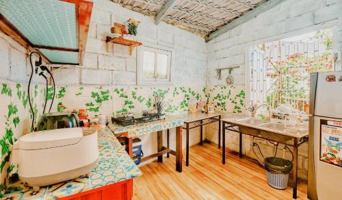 a kitchen with two sinks and a refrigerator at Simplewoods Homestay in Da Lat in Da Lat