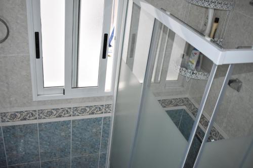 a staircase in a bathroom with two windows at Torri apartments - 3 mins walk to beach in Torrevieja