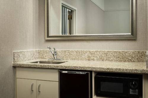 a bathroom with a sink and a microwave at Courtyard Houston Downtown Convention Center in Houston