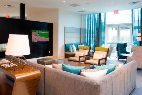 a living room with a couch and a tv at Residence Inn by Marriott The Bronx at Metro Center Atrium in Bronx